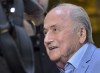 FILE- Former FIFA President Sepp Blatter arrives at a hotel in Moscow, Russia, June 19, 2018. Suspended former FIFA president Sepp Blatter has arrived in Moscow for a World Cup visit at the invitation of Russian President Vladimir Putin. Former FIFA officials Sepp Blatter and Michel Platini will go on trial charged with fraud and other offenses in June, it was announced Tuesday, April 12, 2022. Switzerland’s federal criminal court says the trial will be heard before a panel of three judges on 11 days between June 8 and 22. (AP Photo/Dmitry Serebryakov, file)