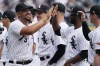 Chicago White Sox's Jose Abreu, left, greets teammates as he runs on the field during an opening day baseball game against the Seattle Mariners in Chicago, Tuesday, April 12, 2022. (AP Photo/Nam Y. Huh)