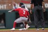 Washington Nationals' Maikel Franco (7) is safe at second base as Atlanta Braves' Ozzie Albies (1) fields the throw after a Braves' error during the first inning of a baseball game Wednesday, April 13, 2022, in Atlanta. (AP Photo/Brynn Anderson)