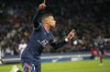 PSG's Kylian Mbappe celebrates after scoring his side's second goal during the French League One soccer match between Paris Saint Germain and FC Lorient at Parc des Princes stadium in Paris, Sunday, April 3, 2022. (AP Photo/Michel Euler)