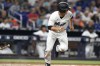 Miami Marlins' Joey Wendle runs to first with a two-run single during the fourth inning of the team's baseball game against the Philadelphia Phillies, Thursday, April 14, 2022, in Miami. (AP Photo/Lynne Sladky)