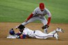 Texas Rangers' Willie Calhoun, bottom, slides into second with a double in front of a tag by Los Angeles Angels shortstop Andrew Velazquez, top, during the fourth inning of a baseball game, Thursday, April 14, 2022, in Arlington, Texas. (AP Photo/Michael Ainsworth)