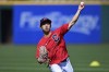 Cleveland Guardians center fielder Steven Kwan throws before a baseball game against the San Francisco Giants, Friday, April 15, 2022, in Cleveland. (AP Photo/David Dermer)