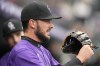 Colorado Rockies left fielder Kris Bryant heads out to his position in the first inning of the team's baseball game against the Chicago Cubs on Saturday, April 16, 2022, in Denver. (AP Photo/David Zalubowski)