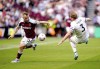 West Ham United's Jarrod Bowen, left, and Burnley's Charlie Taylor battle for the ball during their English Premier League soccer match at the London Stadium, London, Sunday, April 17, 2022. (Adam Davy/PA via AP)