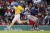 Boston Red Sox's Xander Bogaerts, left, scores behind Minnesota Twins' Gary Sanchez on a sacrifice fly by Alex Verdugo during the sixth inning of a baseball game, Sunday, April 17, 2022, in Boston. (AP Photo/Michael Dwyer)