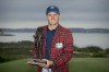 Jordan Spieth holds the championship trophy after winning the RBC Heritage golf tournament, Sunday, April 17, 2022, in Hilton Head Island, S.C. (AP Photo/Stephen B. Morton)