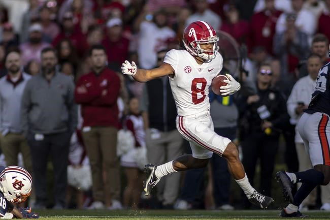Alabama wide receiver John Metchie III (8) gets loose on a pass reception during the first half of an NCAA college football game against Auburn, Saturday, Nov. 27, 2021, in Auburn, Ala. Metchie of the Alabama Crimson Tide moved atop the CFL Scouting Bureau's final list Tuesday of the top-20 prospects for the league's 2022 draft. (AP Photo/Vasha Hunt)