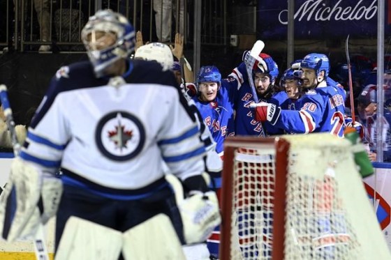 New York Rangers defenseman Adam Fox (23), center Mika Zibanejad (93), center Ryan Strome (16) and left wing Chris Kreider (20) celebrate a goal by Strome against the Winnipeg Jets during the second period of an NHL hockey game, Tuesday, April 19, 2022, in New York. (AP Photo/Jessie Alcheh)