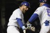 Chicago Cubs' Patrick Wisdom celebrates his pinch-hit, two-run home run off Tampa Bay Rays relief pitcher Josh Fleming with first base coach Mike Napoli during the fourth inning of a baseball game Tuesday, April 19, 2022, in Chicago. (AP Photo/Charles Rex Arbogast)