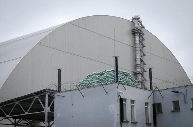 FILE - A Russian firing position sits near a shelter adjacent to the containment structure covering the damaged reactor at the Chernobyl nuclear power plant near Chernobyl, Ukraine, Saturday, April 16, 2022. Thousands of tanks and troops rumbled into the forested exclusion zone around the plant in the earliest hours of Russia’s invasion of Ukraine in February, churning up highly contaminated soil from the site of the 1986 accident that was the world's worst nuclear disaster. (AP Photo/Efrem Lukatsky, File)