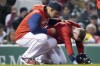 Boston Red Sox's Trevor Story kneels after after getting hit on the helmet by a pitch thrown by Toronto Blue Jays' Jose Berrios during the third inning of a baseball game Wednesday, April 20, 2022, at Fenway Park in Boston. Story stayed in the game. At left is manager Alex Cora. (AP Photo/Charles Krupa)