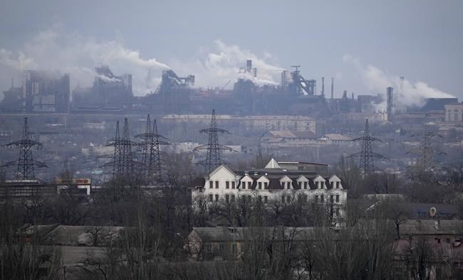 FILE - A metallurgical plant is seen on the outskirts of the city of Mariupol, Ukraine, Thursday, Feb. 24, 2022. Russia began evacuating its embassy in Kyiv, and Ukraine urged its citizens to leave Russia. Russian President Vladimir Putin ordered his forces not to storm the last remaining Ukrainian stronghold in the besieged city of Mariupol but to block it