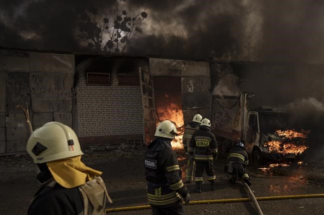 Firefighters battle a fire at a warehouse after a Russian bombardment in Kharkiv, Ukraine, Thursday, April 21, 2022. (AP Photo/Felipe Dana)