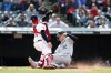 Chicago White Sox's Gavin Sheets scores against Cleveland Guardians' Austin Hedges during the seventh inning of a baseball game, Thursday, April 21, 2022, in Cleveland. (AP Photo/Ron Schwane)