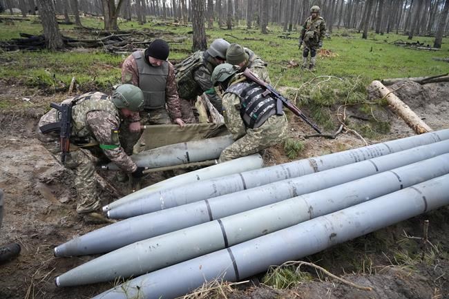 Ukrainian soldiers collect multiple Russian 'Uragan' missiles after recent fights in the village of Berezivka, Ukraine, Thursday, April 21, 2022. (AP Photo/Efrem Lukatsky)
