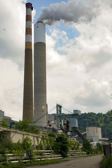 FILE - In this June 10, 2021 photo, a flume of emissions flow from a stack at the Cheswick Generating Station, a coal-fired power plant, in Springdale, Pa. Pennsylvania on Saturday, April 23, 2022, will become the latest state in the U.S. to adopt a carbon pricing policy to address climate change. (AP Photo/Keith Srakocic, File)