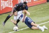CF Montreal's Victor Wanyama challenges Vancouver Whitecaps' Lucas Cavallini (9) during second half MLS soccer action in Montreal, Saturday, April 16, 2022. THE CANADIAN PRESS/Graham Hughes