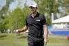 Patrick Cantlay walks off the 18th green after his putt during the second round of the PGA Zurich Classic golf tournament, Friday, April 22, 2022, at TPC Louisiana in Avondale, La. (AP Photo/Gerald Herbert)