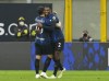 Inter Milan's Denzel Dumfries, right, celebrates with teammate Inter Milan's Hakan Calhanoglu after scoring his side's opening goal during the Serie A soccer match between Inter Milan and Roma at the San Siro Stadium, in Milan, Italy, Saturday, April 23, 2022. (AP Photo/Antonio Calanni)