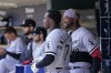 Chicago White Sox shortstop Tim Anderson talks with left fielder Eloy Jimenez in the dugout during the fourth inning of a baseball game against the Detroit Tigers, Sunday, April 10, 2022, in Detroit. (AP Photo/Carlos Osorio)