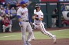Arizona Diamondbacks' Daulton Varsho advances to third on a base hit by David Peralta during the first inning of a baseball game as New York Mets' Eduardo Escobar waits for the throw, Saturday, April 23, 2022, in Phoenix. (AP Photo/Matt York)