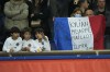 PSG's fans support their team during the French League One soccer match between Paris Saint Germain and Lens at Parc des Princes stadium in Paris, Saturday, April 23, 2022. The sign on French flag reads 