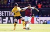 Wolverhampton Wanderers' Hwang Hee-chan, left, and Burnley's Dwight McNeil battle for the ball during the English Premier League soccer match at Turf Moor, Burnley, England, Sunday April 24, 2022. (Martin Rickett/PA via AP)