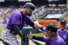 Colorado Rockies' Randal Grichuk is greeted at the dugout after his two-run home run during the third inning of an interleague baseball game against the Detroit Tigers, Sunday, April 24, 2022, in Detroit. (AP Photo/Carlos Osorio)