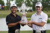 Xander Schauffele, left, and Patrick Cantlay, right, hold up the trophy after winning the PGA Zurich Classic golf tournament at TPC Louisiana in Avondale, La., Sunday, April 24, 2022. (AP Photo/Gerald Herbert)