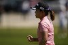 Nasa Hataoka reacts after sinking a putt on the first green during the final round of LPGA's DIO Implant LA Open golf tournament at Wilshire Country Club on Sunday, April 24, 2022, in Los Angeles. (AP Photo/Ashley Landis)