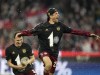 Bayern's Thomas Mueller, right, and Bayern's Benjamin Pavard celebrate at the end of the German Bundesliga soccer match between Bayern Munich and Borussia Dortmund, at the Allianz Arena, in Munich, Germany, Saturday, April 23, 2022. (AP Photo/Matthias Schrader)