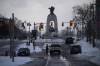 The National War Memorial is seen behind an overcast sky as police man a fence along Queen Street as they clear the streets near Parliament Hill to end to a protest, which started in opposition to mandatory COVID-19 vaccine mandates and grew into a broader anti-government demonstration and occupation, on its 23rd day, in Ottawa, Saturday, Feb. 19, 2022. One of the organizers of a planned motorcycle convoy is warning of a 
