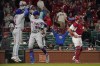 New York Mets' Brandon Nimmo (9) is congratulated by teammate Dominic Smith (2) after hitting a two-run home run as St. Louis Cardinals catcher Andrew Knizner, right, stands at the plate during the ninth inning of a baseball game Monday, April 25, 2022, in St. Louis. (AP Photo/Jeff Roberson)