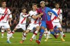 Barcelona's Ronald Araujo, second from right, and Rayo's Nikola Maras challenge for the ball during a Spanish La Liga soccer match between FC Barcelona and Rayo Vallecano at the Camp Nou stadium in Barcelona, Spain, Sunday, April 24, 2022. (AP Photo/Joan Monfort)