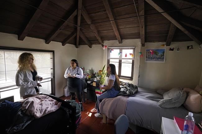 From left, University of California, Berkeley students Sofia Howard-Jimenez, Jennifer Lopez, and Aisha Wallace-Palomares talk in a loft bedroom of the apartment they share with one other in Berkeley, Calif., Tuesday, March 29, 2022. Millions of college students in the U.S. are trying to find an affordable place to live as rents surge nationally, affecting seniors, young families and students alike. (AP Photo/Eric Risberg)