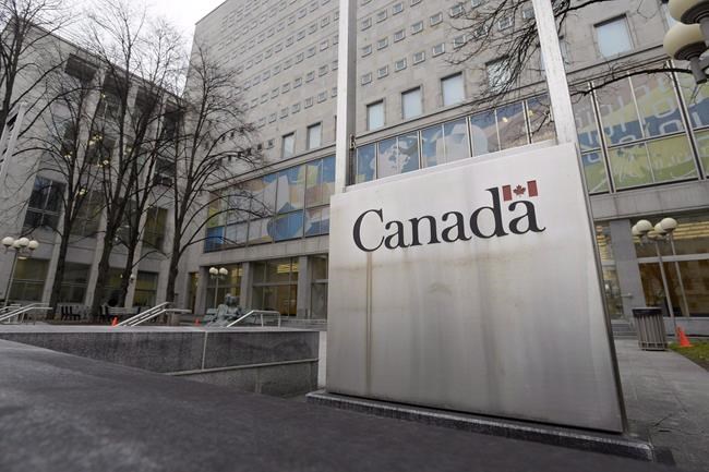 A Government of Canada sign sits in front of a Library and Archives Canada building next to Parliament Hill in Ottawa on November 25, 2014. A new report says Library and Archives Canada is frequently failing to answer formal requests for historical records in a timely way. THE CANADIAN PRESS/Adrian Wyld