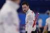 Canada's Brett Gallant looks back after sweeping during a men's curling match against the United States at the Beijing Winter Olympics Sunday, Feb. 13, 2022, in Beijing. THE CANADIAN PRESS/AP/Brynn Anderson
