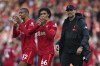 Liverpool's manager Jurgen Klopp, Liverpool's Trent Alexander-Arnold, center, and Liverpool's Joel Matip celebrate after the English Premier League soccer match between Liverpool and Everton at Anfield stadium in Liverpool, England, Sunday, April 24, 2022. (AP Photo/Jon Super)