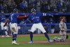 Toronto Blue Jays centre fielder George Springer (4) reacts with teammate Toronto Blue Jays second baseman Santiago Espinal (5) after hitting a two run home run to tie the game during ninth inning American League MLB baseball action in Toronto on Tuesday, April 26, 2022. THE CANADIAN PRESS/Nathan Denette