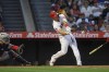 Los Angeles Angels' Mike Trout, right, hits a two-run home run as Cleveland Guardians catcher Austin Hedges watches during the third inning of a baseball game Tuesday, April 26, 2022, in Anaheim, Calif. (AP Photo/Mark J. Terrill)