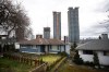 Condo towers under construction rise up a few blocks away from houses, in Burnaby, B.C., on Wednesday, March 2, 2022. The latest census data shows single-detached homes are still the most plentiful type of housing in Canada, but apartments and row houses are catching up. THE CANADIAN PRESS/Darryl Dyck