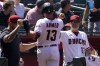 Arizona Diamondbacks' Nick Ahmed (13) is greeted by manager Torey Lovullo (17) after hitting a solo home run against the Los Angeles Dodgers during the fifth inning of a baseball game, Wednesday, April 27, 2022, in Phoenix. (AP Photo/Matt York)