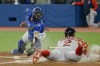 Boston Red Sox shortstop Xander Bogaerts (2) slides into home base to score during first inning MLB baseball action against the Toronto Blue Jays in Toronto on Wednesday, April 27, 2022. THE CANADIAN PRESS/Christopher Katsarov