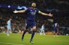 Real Madrid's Karim Benzema celebrates after scoring his side's third goal from penalty during the Champions League semi final, first leg soccer match between Manchester City and Real Madrid at the Etihad stadium in Manchester, England, Tuesday, April 26, 2022. (AP Photo/Dave Thompson)