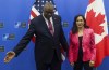 U.S. Secretary for Defense Lloyd J. Austin III, left, and Canadian Defense Minister Anita Anand pose for a photo prior to a meeting at NATO headquarters in Brussels, Thursday, March 17, 2022. Anand is headed to the Pentagon to meet with her American counterpart as the war in Ukraine injects new urgency into cross-border military priorities. (Yves Herman, Pool Photo via AP)
