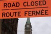 A sign indicates a road closure near Parliament Hill, Wednesday, April 27, 2022 in Ottawa.&nbsp;Ottawa's interim police chief is warning a planned biker convoy that the city will not tolerate any sort of longer term occupation of the capital. Interim police chief Steve Bell delivered the warning this morning, as hundreds of bikers prepare to descend on the city starting Friday.&nbsp;THE CANADIAN PRESS/Adrian Wyld