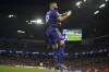 Real Madrid's Karim Benzema celebrates after scoring his side's third goal from penalty during the Champions League semi final, first leg soccer match between Manchester City and Real Madrid at the Etihad stadium in Manchester, England, Tuesday, April 26, 2022. (AP Photo/Dave Thompson)
