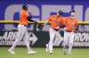 Houston Astros' Yordan Alvarez, left, Chas McCormick, center, and Kyle Tucker, right, celebrate their 3-2 win in a baseball game against the Texas Rangers, Thursday, April 28, 2022, in Arlington, Texas. (AP Photo/Tony Gutierrez)