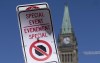 A temporary no-stopping sign is fixed with paper clips to a road sign near Parliament Hill, Thursday, April 28, 2022 in Ottawa. The area is part of a motorized vehicle exclusion zone set by the Ottawa Police Service. THE CANADIAN PRESS/Adrian Wyld